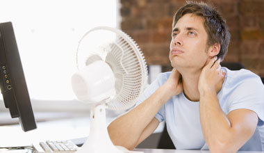 Jacksonville Florida Air Conditioning Repair, Man in front of fan cooling off